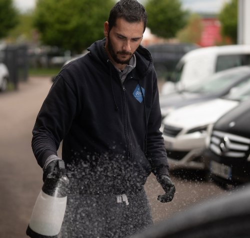 Pulvérisation d'un produit de décontamination sur une carrosserie